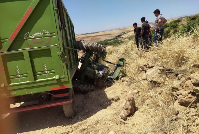 Devrilen traktörün altında kalan 2 kişi yaralandı